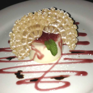 Grotto panna cotta with lemon, raspberry sauce, crispy pizzelle cookie and aged balsamic
