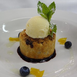 L'Andana blueberry crostata with cinnamon crumble, vanilla gelato, blueberry coulis and lemon syrup